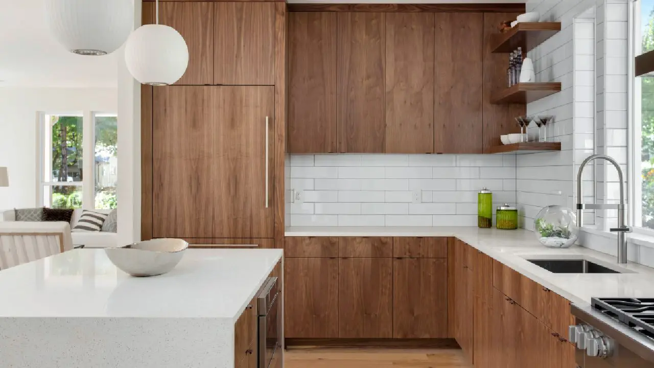 A kitchen with wooden cabinets and white counters.