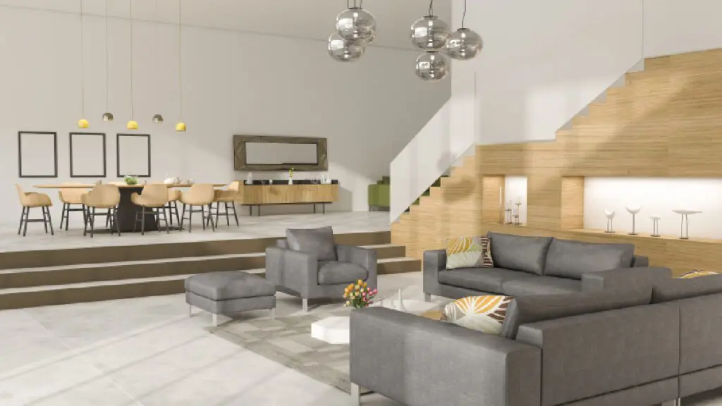 A living room with gray furniture and stairs.