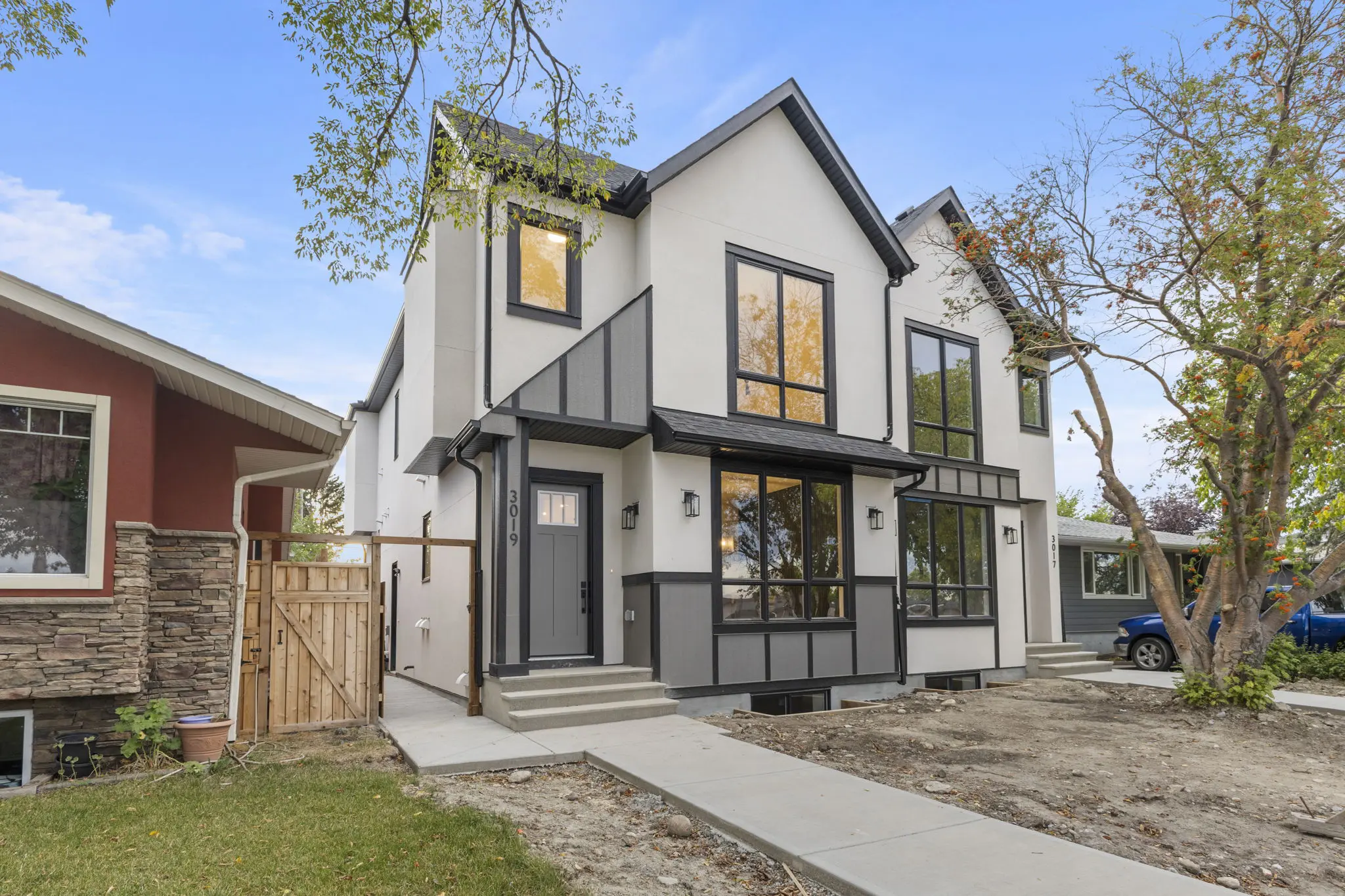 A white and black house with a fence
