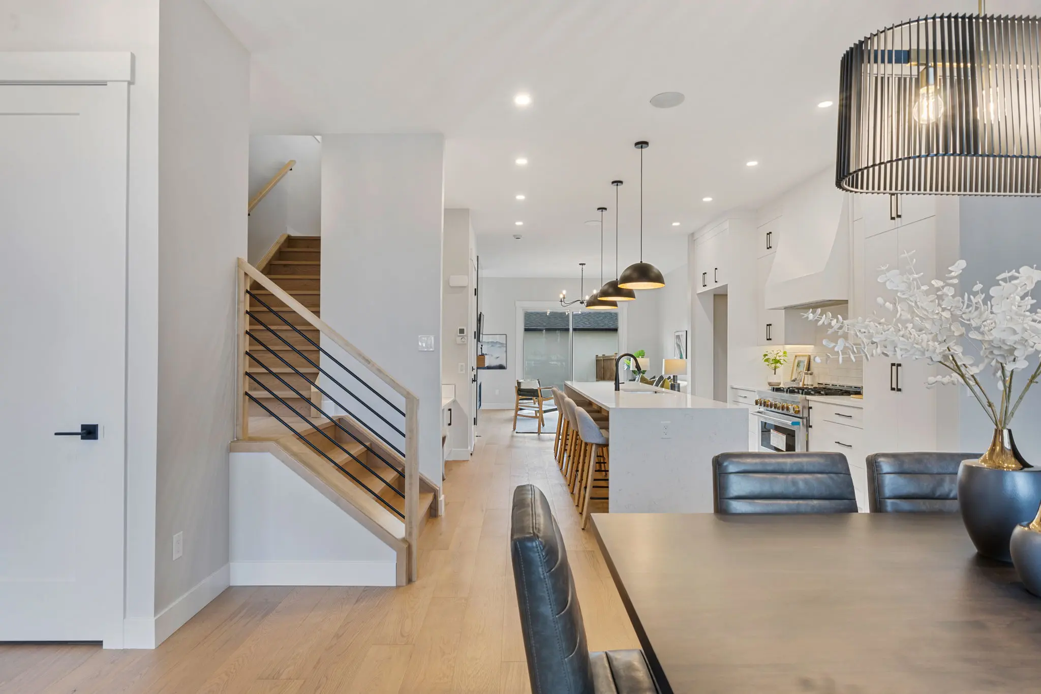 A view of the kitchen and living room from across the table.