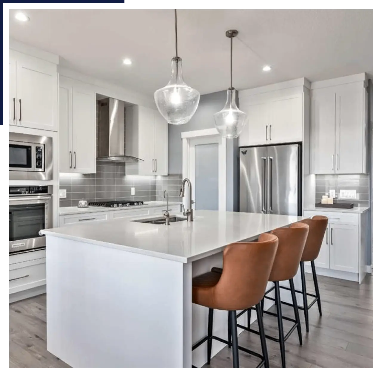 home_-_3rd_section1.png (1) A kitchen with white cabinets and brown chairs